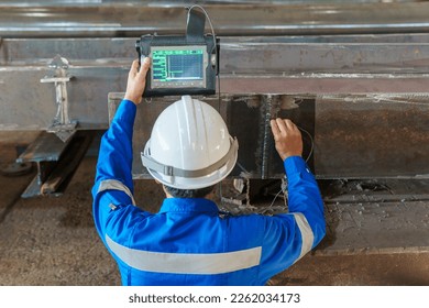Inspectors are Inspection defects in Welded Steel H-beam add joints with Process Ultrasonic Testing (UT) of Non-Destructive Testing (NDT) - Shutterstock ID 2262034173