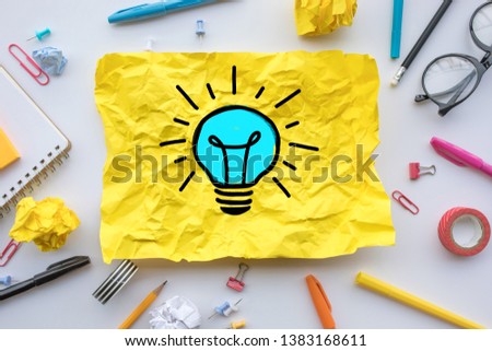 Inspiration creativity concepts with lightbulb in paper crumpled ball on worktable.Business ideas solution and human performance.Top view 