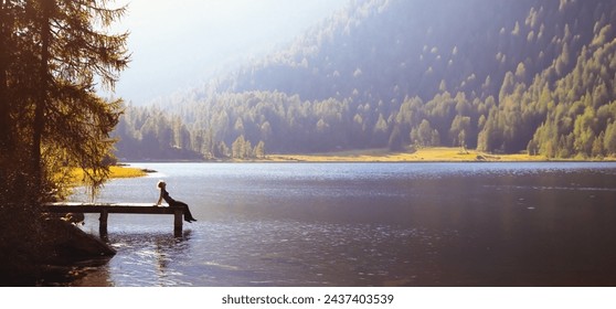 inspiration and happiness, life force and energy, harmony of nature, body, mind and soul, happy woman sitting on the pier on lake - Powered by Shutterstock