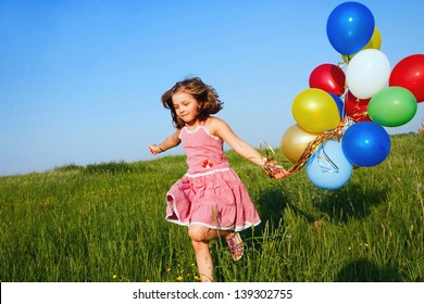 inspiration, happy little girl jumping outdoors with balloons