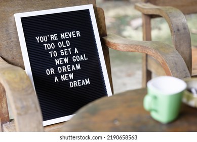 Inspiration Quote, You're Never Too Old To Set A New Goal, Or Dream A New Dream, On The Letter Board Sign, And Placed On The Old Chair At Home