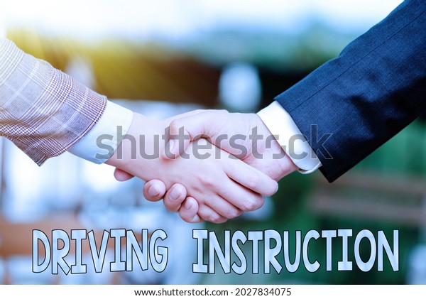 Inspiration showing sign Driving Instruction.\
Internet Concept detailed information on how driving should be done\
Two Professional Well-Dressed Corporate Businessmen Handshake\
Indoors