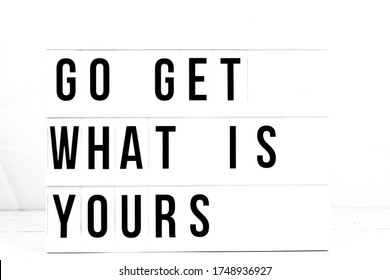 Inspirational Go Get What Is Yours quote on vintage retro board. Concept. flat lay