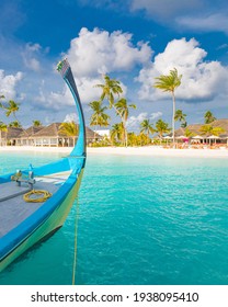 Inspirational Maldives beach design. Maldives traditional boat Dhoni and perfect blue sea with lagoon. Luxury tropical resort hotel paradise view. Idyllic coast, shore with white sand, palm trees