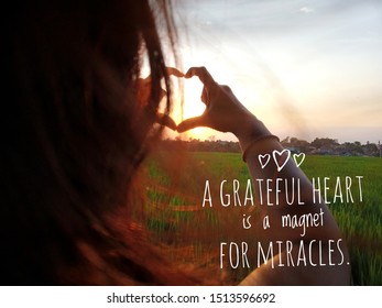 Inspirational motivational quote - A grateful heart is a magnet for miracles. with woman making heart shape during sun rise, Heart shape, Symbol of love, The manifestation of love,  - Shutterstock ID 1513596692