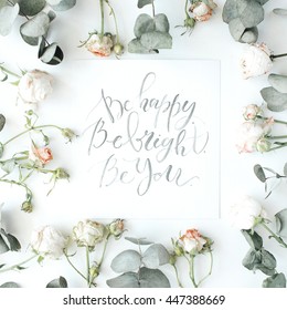 inspirational quote be happy, be bright, be you written in calligraphy style on paper with pink roses and eucalyptus branches on white background. flat lay, top view – Ảnh có sẵn