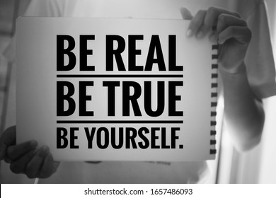 Inspirational quote - Be real. Be true. Be yourself. With young girl holding white paper book sign with reminder notes. Self confident motivational words concept in black and white background.