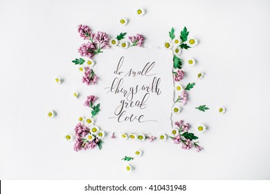 inspirational quote "Do small things with great love" written in calligraphy style on paper with wreath frame with lilac and chamomile isolated on white background. flat lay, overhead view, top view - Powered by Shutterstock