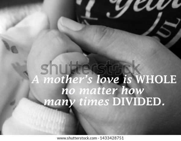 Inspirational quote- a mothers love is whole. No\
matter how many times divided. With blurry image of a fragile\
little baby new born hand and fingers holds by her his mother hand\
in black and\
white.