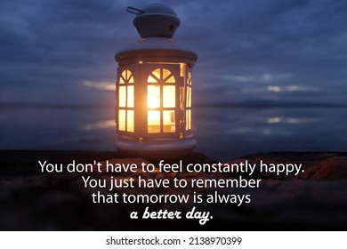 Inspirational Quote - You Don't Have To Feel Constantly Happy. You Just Have To Remember That Tomorrow Is Always A Better Day. With Lantern Light On The Beach At Night. Hope Concept.
