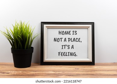 Inspirational quotes text in a frame - home is not a place, it's a feeling. - Powered by Shutterstock