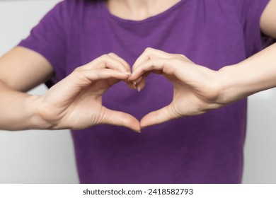 Inspire inclusion. Zoomers symbolize love. Woman finger heart dressed purple t-shirt. Hand showing heart. International Women's Day 2024, inspireInclusion.
