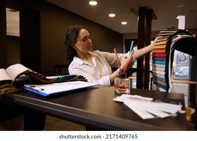 Inspired Hispanic Woman Interior Designer, Sales Representative Using Mobile Phone To Photograph New Upholstery Fabric Samples In Creative Art And Home Design Workshop. Style Home Improvement Concept