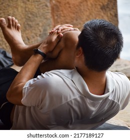 Inspired Indian Young Man Doing Yoga Asanas In Lodhi Garden Park, New Delhi, India. Young Citizen Exercising Outside And Standing In Yoga Side Angle Pose. Fitness Outdoors And Life Balance Concept