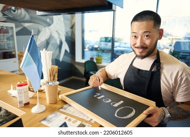 Inspired Male Chef Posing Gladly With Chalkboard Sign Saying Open