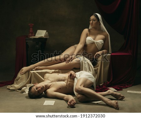 Inspired. Modern remake of classical artwork - young medieval couple on dark background, golden colored. Concept of art, creativity, comparison of eras, history, modernity and renaissance.