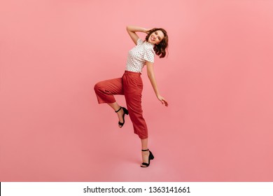 Inspired Slim Girl Dancing On Pink Background. Studio Shot Of Graceful Trendy Woman In Black Shoes.