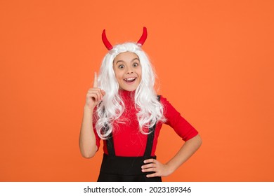 inspired teenage child in imp horns. cheerful kid has an idea. feel the inspiration. carnival costume party. trick or treat. celebrate the holidays. childhood. happy halloween devil girl