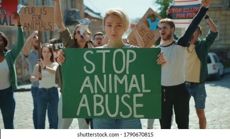 Inspiring Man Leader Agitating Crowd With Loudspeaker Outdoors. Multi-ethnic Active Urban Youth Protesting For Animal Rights And Safe Ecology In Public Demonstration.