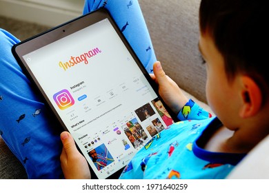 Instagram Kids app concept. Child is holding device with instagram app in his hands. Child privacy and children data protection in social media. Stafford, United Kingdom, May 11, 2021