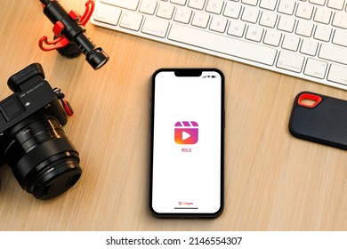 Instagram Reels App On Smartphone IPhone Screen On Wooden Table. Content Creator Environment With Keyboard, Camera And Mic. Rio De Janeiro, RJ, Brazil. April 2022.