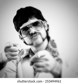 Instagram Style Portrait Of A Retro Man In A 1970s Leisure Suit And Sunglasses Pointing To The Camera - Black And White