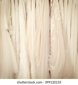 Instagram-style Image Of Wedding Dresses Hanging On A Rack.