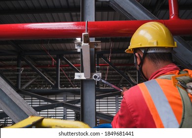 Install Fire Sprinkler System. In The Industrial Plant, Pipe Assembly, Red Fire Pipe, Fire Protection Contractors Using Scissor Lift High Work