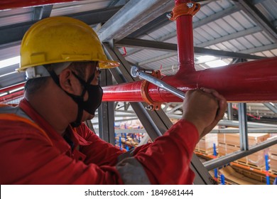 Install fire sprinkler system. In the industrial plant, pipe assembly, red fire pipe, fire protection contractors Using Scissor Lift High work - Shutterstock ID 1849681444