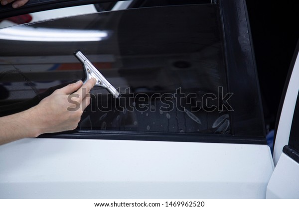 Install windows film on the car. Tinted Windows of
the car.