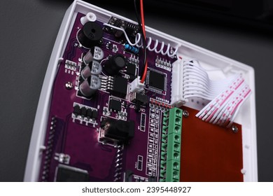 Installation of alarm system. Circuit board on gray wall, closeup - Shutterstock ID 2395448927
