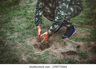 Installation Of Anti Tank Mines. A Soldier Sets A Mine In The Ground. Copy Space For Text