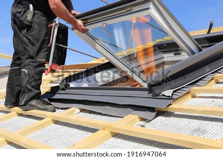 Installation and assembly of new roof windows as part of a roof covering ストックフォト © 