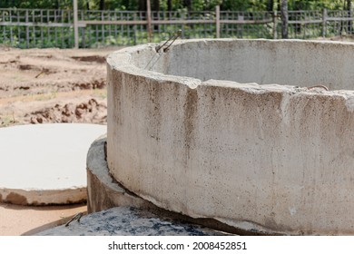 Installation of concrete sewer wells in the ground at the construction site. The use of reinforced concrete rings for cesspools, overflow septic tanks. Improvement of wells and storm sewage
