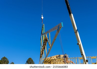 Installation construction wooden framework of crane holds roof beams frame trusses house