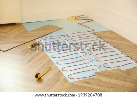 Installation of electric underfloor heating system indoors
