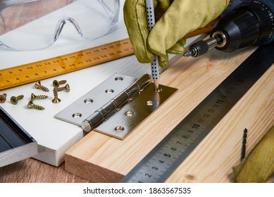 Installation Of Furniture Hinges In The Chipboard, Tools And Accessories Needed To Perform The Work. Small Carpentry Work At Home, The Concept Of A Home Master, Self-repair Of The House