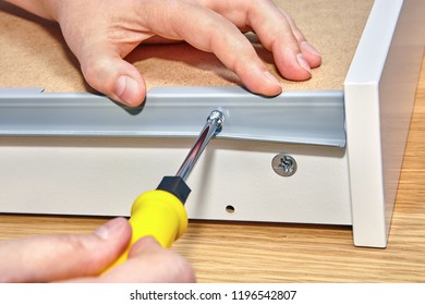 Installation Furniture, Screwing Screw-bolt With Using Hand Screwdriver, Close-up.