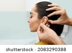 Installation hearing aid on woman
