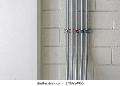 Installation of IMC conduit on the wall for electrical system work