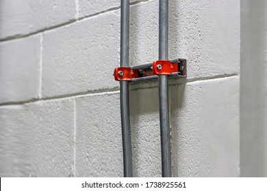 Installation of IMC conduit on the wall for electrical system work