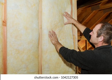 Installation Of Inside Wall Insulation In Wooden House, Building Under Construction