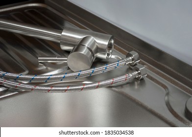 Installation Of The Kitchen Faucet To A Sink. A Kitchen Faucet Is Fitted With Hoses For Installation