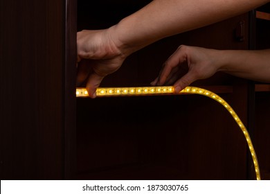 Installation of LED strip, glowing ribbon close-up.
