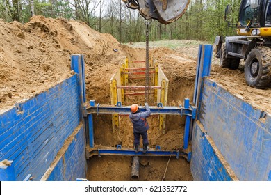 Installation Of Metal Supports To Protect The Walls Of The Trench. The Lining Protects The Walls From Collapsing And Save The Workers.