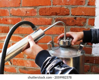 Installation Of A Moonshine Still Made Of Stainless Steel On A Street In A Rural Courtyard, Production Of Homemade Strong Drink From Fruit, Distillation System For Making Calvados And Chacha