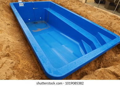 Installation Plastic Fiberglass Pool In The Ground At House Backyard. Construction Site