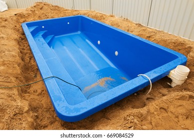 Installation Plastic Fiberglass Pool In The Ground At House Backyard. Construction Site