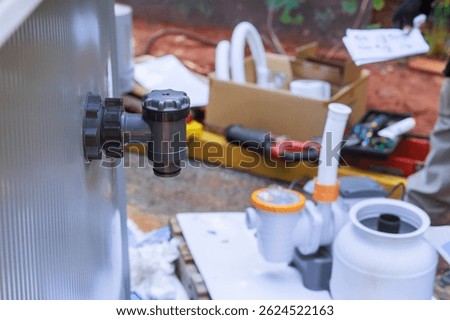 Installation process of water pump filter tank system at residential swimming pool during works maintenance