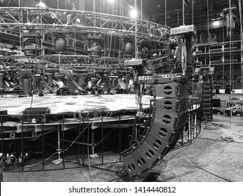 Installation of professional concert equipment. Lifting of line array speakers. Truss with spot lighting equipment above the stage.